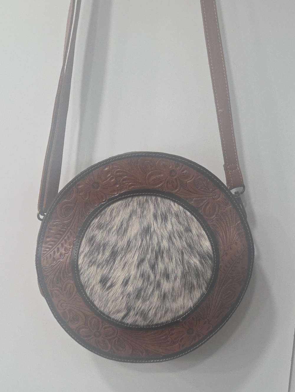 Myra Bag Brown Tooled Leather Round Crossbody with Black-and-White Hair-On Hide